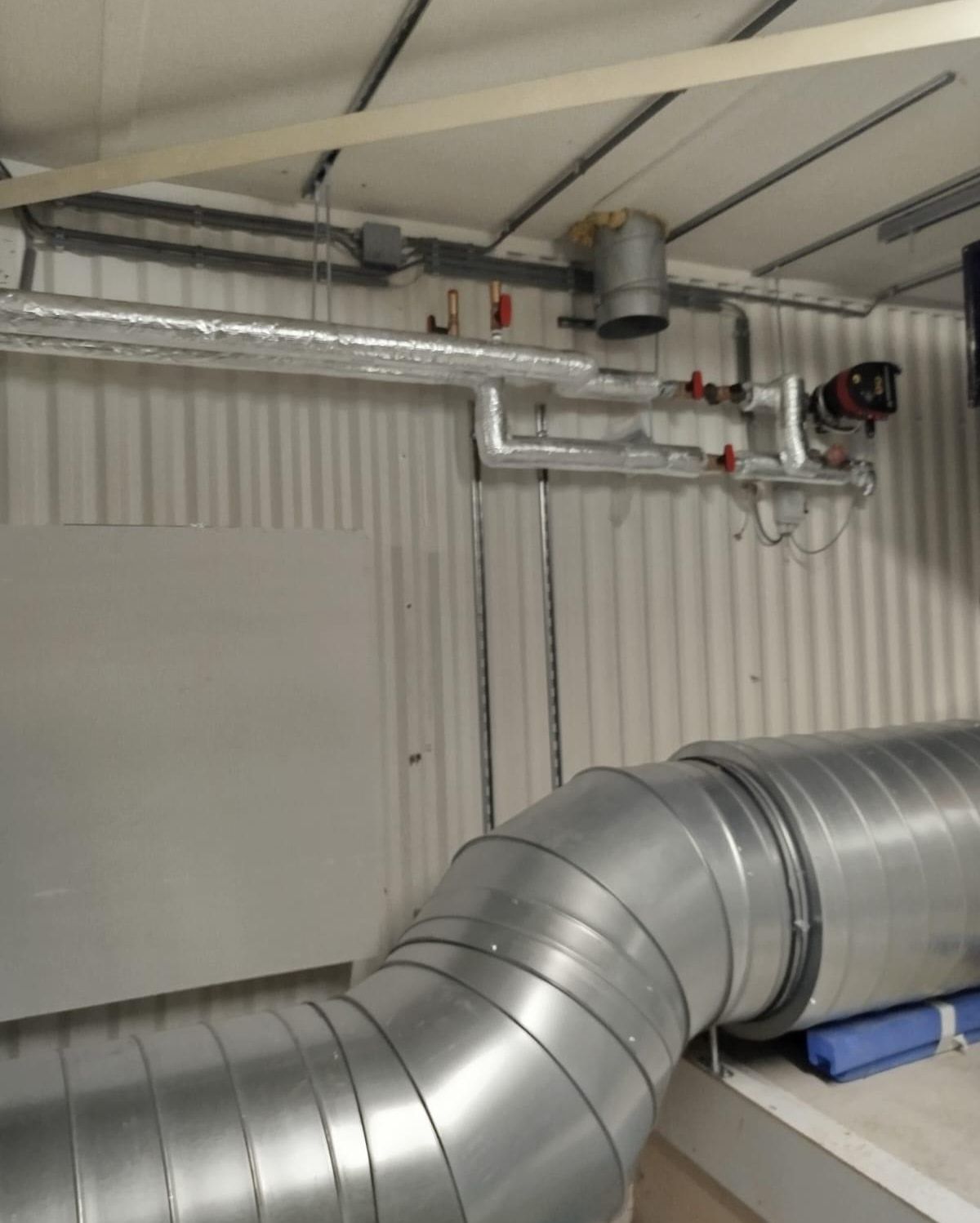 Insulated spiral ducts and pipework in a plant room